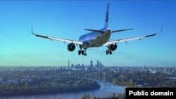 A commercial aircraft prepares to land over a city.