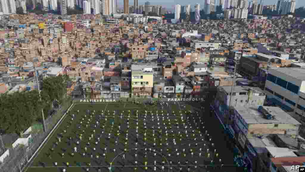 브라질 상파울루의 파라이조폴리스에서 주민들이 축구 경기장에서 열린 행사에 참석했다. 인구 밀도가 높은 파라이조폴리스 지역에서 신종 코로나바이러스 감염증 환자가 10만 여명을 기록했다.