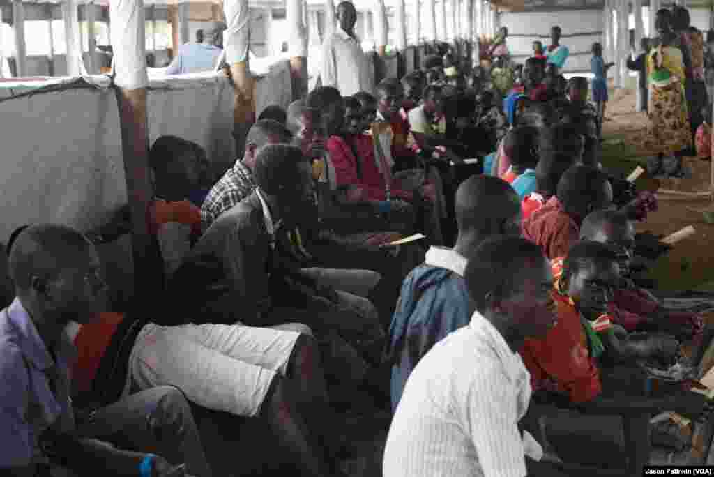 Refugees wait for a final round of registration at a reception center.
