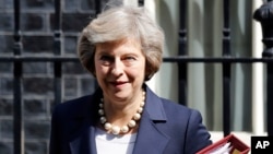 FILE- Britain's Prime Minister Theresa May leaves 10 Downing street in London, July 20, 2016. ﻿On her first visit to China as Britain’s prime minister, Theresa May will try to reassure Beijing that she wants to strengthen ties despite her delay on a decision over whether to approve a Chinese-backed nuclear power plant in southwestern England. 