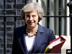 FILE- Britain's Prime Minister Theresa May leaves 10 Downing street in London, July 20, 2016. ﻿On her first visit to China as Britain’s prime minister, Theresa May will try to reassure Beijing that she wants to strengthen ties despite her delay on a decis