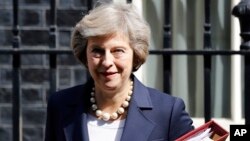 FILE- Britain's Prime Minister Theresa May leaves 10 Downing street in London, July 20, 2016. ﻿On her first visit to China as Britain’s prime minister, Theresa May will try to reassure Beijing that she wants to strengthen ties despite her delay on a decis