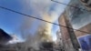 Smoke rises near a giant portrait of the late Hezbollah military commander Imad Mughniyeh after a building was hit by an Israeli airstrike in Dahiyeh, a southern suburb of Beirut, Lebanon, Oct. 20, 2024. 