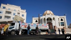 After a Tuesday night suicide bombing next to a mosque, people gather at the site in Sana'a, Yemen, Oct. 7, 2015. Islamic State militants claimed responsibility for the blast, which killed seven people.