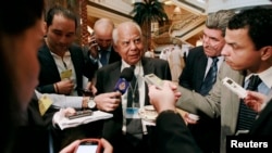 Egypt's then-Finance Minister Hazem el-Beblawi addressing media in Abu Dhabi, Sept. 7, 2011.