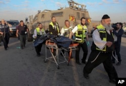 Israeli emergency services evacuate the body of a Palestinian from the scene of an attack near the West Bank Gush Etzion settlements, Nov. 22, 2015.