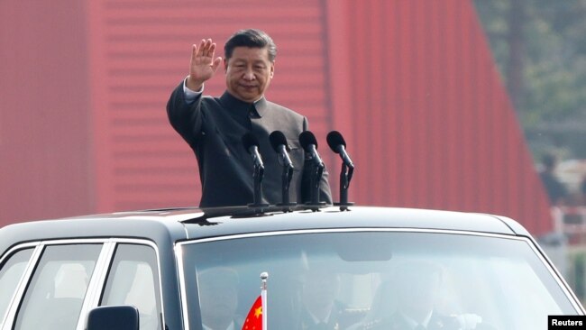 中国国家主席习近平在北京天安门广场举行的阅兵式上乘车检阅。(2019年10月1日)