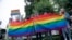 FILE – LGBTQ+ activists wave flags at a rally in Moscow on July 15, 2020. 