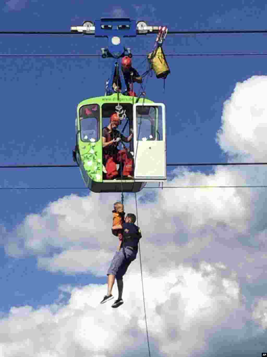 Members of the fire service rescue people from a cable car gondola, in Cologne, Germany, July 30, 2017.