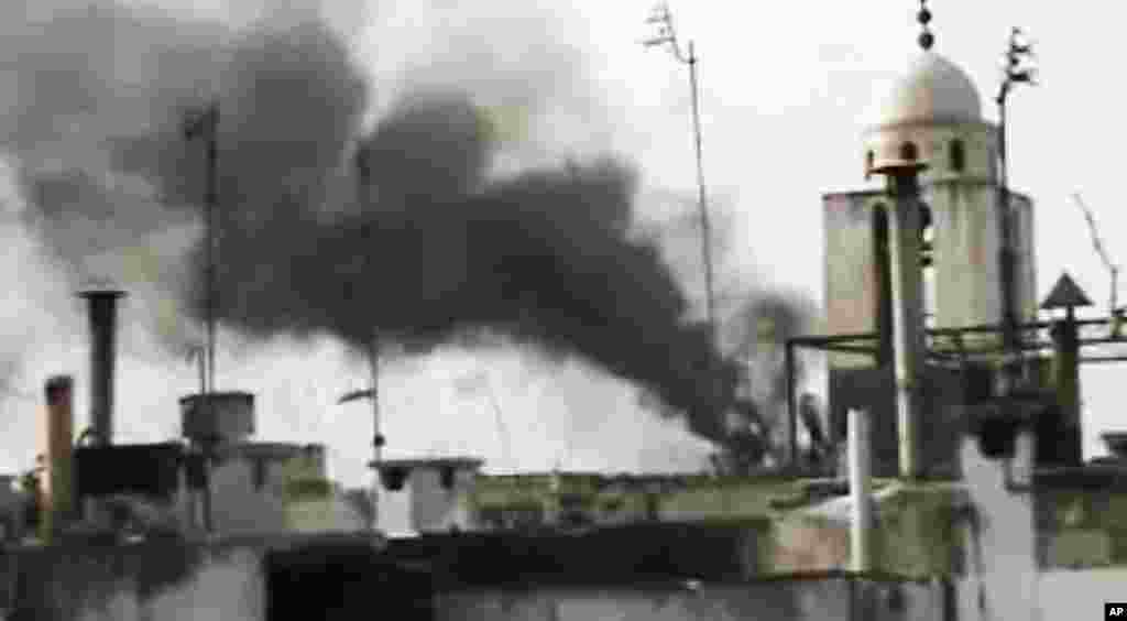 This image from amateur video purports to show smoke rising from buildings in Homs that were shelled by Syrian troops, March 26, 2012. (AP/SHaam)