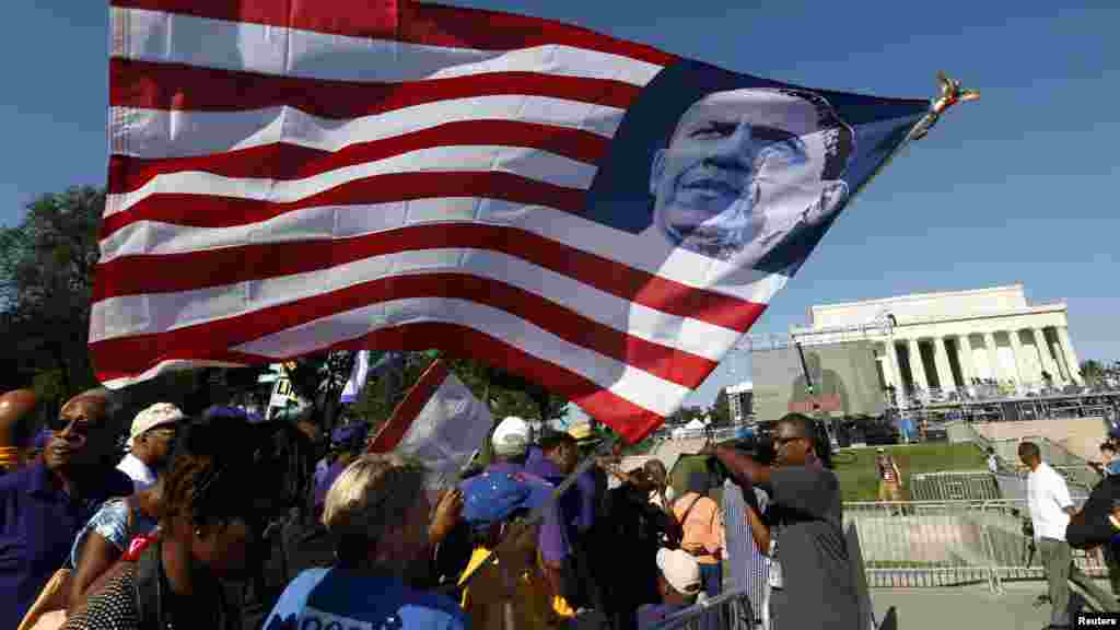Crowds line the Reflecting Pool to watch the 50th anniversary ceremony of the 1963 March on Washington ceremony, with the Washington Monument in the backround, Aug. 24, 2013. 