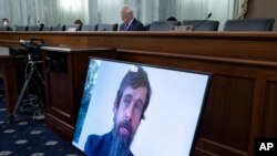 Twitter CEO Jack Dorsey appears on a screen as he speaks remotely during a hearing before the Senate Commerce Committee on Capitol Hill, Oct. 28, 2020, in Washington.