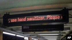 A MTA subway information ticker cautions riders on how to take preventive measures as concerns grow around COVID-19, March 3, 2020, in New York. 