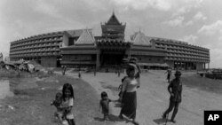 As Phnom Penh refugee camps go, this one is almost swanky. The 215 rooms command a view of the confulence of Cambodia's two rivers, but the 3,500 refugees cannot use them. 