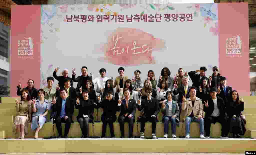 韩国文化体育观光部长官都钟焕率领韩国一个艺术团赴朝演出前在首尔金浦国际机场合影，打出胜利的手势。（2018年3月31日）