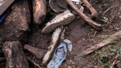 FILE — Shoes are seen after floodwater washed away houses and people, in Kamuchiri Village Mai Mahiu, Nakuru County, Kenya, on April 30, 2024.