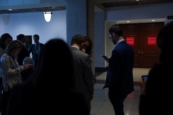 Reporters wait outside of a closed hearing room while Intelligence Community Inspector General Michael Atkinson testifies on a whistleblower complaint, on Capitol Hill, in Washington, Sept. 19, 2019.