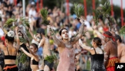 FILE - Jordan O'Davis, center, who is Aboriginal, performs with the Buja Buja dance troupe during the Wugulora Indigenous Morning Ceremony as part of Australia Day celebrations in Sydney, Australia, Jan. 26, 2020. 