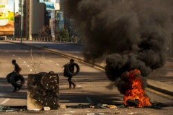 Protesters burn tires to close the main road, after the Lebanese pound hit a record low against the dollar on the black market, in Beirut, Lebanon, March 6, 2021.
