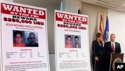 FILE - Laura E. Duffy, United States Attorney Southern District of California, and FBI Special Agent in Charge, James L. Turgal, Jr., right, announce the indictments on five suspects involved in the death of U.S. Border Patrol agent Brian Terry in Tucson,
