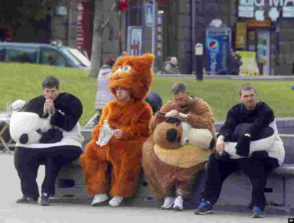 People dressed as cartoon characters to promote the Eurovision Song Contest, take a break in Kiev, Ukraine.