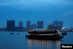 A boat passes buildings under construction on Diamond Island also known as 'Koh Pich', as seen from Tonle Chaktomuk river in Phnom Penh, Cambodia, May 22, 2018.