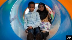 In this photo taken Aug. 21, 2016, Somali children play at the Peace Garden public park in Mogadishu, Somalia. War-weary Somalis are trying to relax and rebuild their country after decades of violence, but the homegrown Islamic extremists al-Shabab keep striking at the heart of its seaside capital, killing scores of people so far this year.