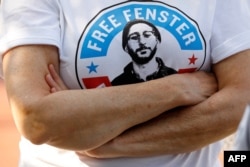 FILE - A person wears a T-shirt calling for the release of U.S. journalist Danny Fenster in Huntington Woods, Michigan, on June 4, 2021.