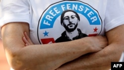 FILE - A person wears a t-shirt calling for the release of American journalist Danny Fenster in Huntington Woods, Michigan, June 4, 2021.