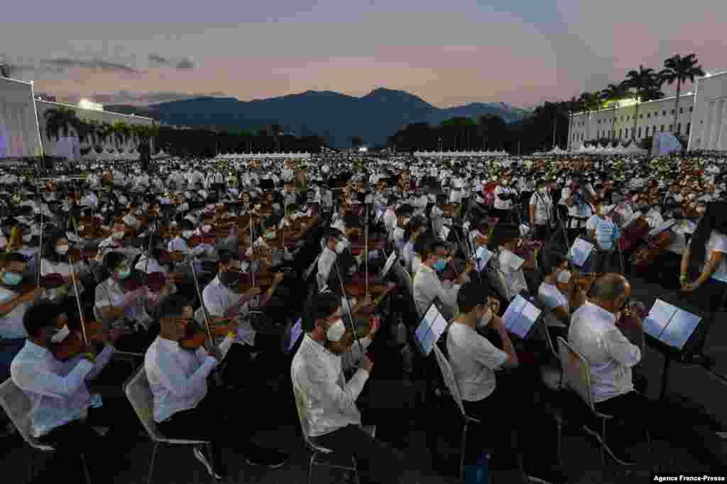 Members of the National System of Orchestras of Venezuela play during an attempt to enter the Guinness Book of Records for the largest orchestra in the world, with more than 12,000 musicians, at the Military Academy of the Bolivarian Army in Fuerte Tiuna Military Complex, in Caracas, Nov. 13, 2021.