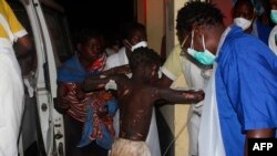 A badly burned child arrives at the Provincial Hospital in Tete, Mozambique, Nov. 17, 2016, after a truck carrying petrol burst into flames.