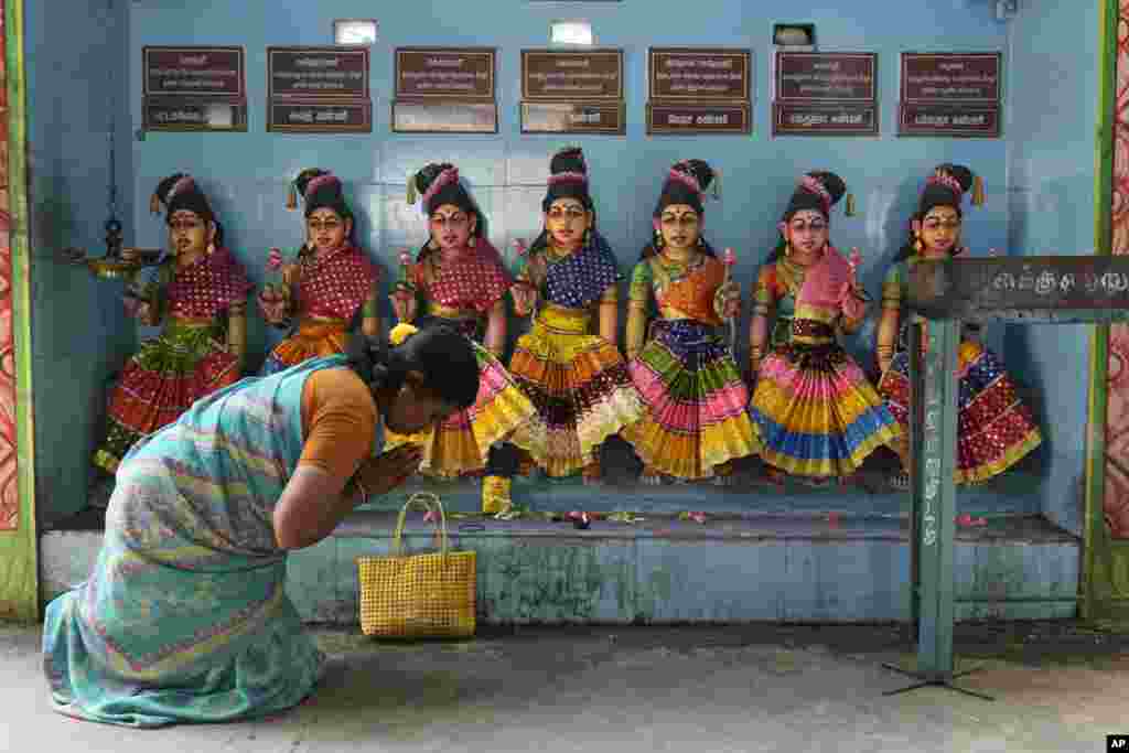 A villager prays in front of the idols of Hindu goddesses after special prayers for the victory of Democratic presidential nominee Vice President Kamala Harris, at Sri Dharmasastha temple in Thulasendrapuram,&nbsp;the ancestral village of Harris, in Tamil Nadu state, India.