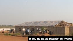 South Sudanese bustle about outside the 14-square-meter structure that has been covered with plastic sheeting and turned into a place of worship in the U.N. House IDP camp in Juba, in the days before Christmas 2014.