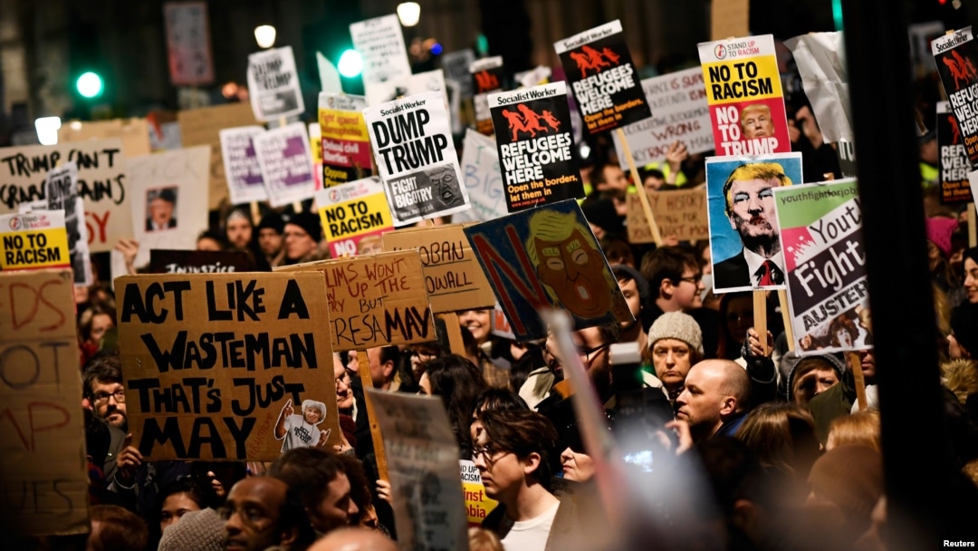 Demonstrators hold placards during a protest against U.S. President Donald Trump's executive order travel ban in London, Britain, Jan. 30, 2017. 
