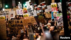 Demonstrators hold placards during a protest against U.S. President Donald Trump's executive order travel ban in London, Britain, Jan. 30, 2017. 