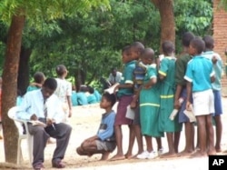 Primary school teacher marks students' work in Malawi's southern district of Phlombe.