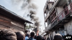 Residents react after a small aircraft crashed in a densely pulated area in Goma, eastern Democratic Republic of Congo, Nov. 24, 2019.