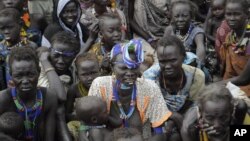 Victims of ethnic violence in Jonglei state, South Sudan, wait in line at the World Food Program distribution center in Pibor to receive emergency food rations, January 12, 2012.