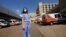 Anne Sinclair, a pediatric emergency room nurse at the University of Mississippi Medical Center, in Jackson, stands in the middle of the filled ambulance bay, Aug. 25, 2021.