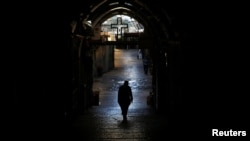 A priest walks in the Christian Quarter of Jerusalem's Old City, June 21, 2016. A recent wave of violence by Muslims on Jews has raised anxiety in the minority Christian community. 