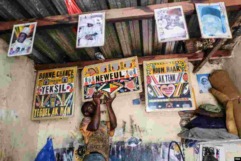 Neyoo Diallo paints cars rapide, the iconic minibuses that barrel down Dakar's roadways. The decorations have evolved over the years and have cultural significance. (R. Shryock/VOA)