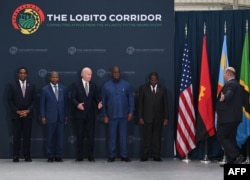 Zambian President Hakainde Hichilema, Angolan President Joao Lourenco, U.S. President Joe Biden, DRC President Felix Tshisekedi and Tanzanian Vice President Philip Isdor Mpango pose for a photo in Benguela, Angola, on Dec. 4, 2024.