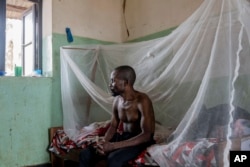 FILE - A man suffering from mpox waits for treatment at the Kamituga General Hospital in South Kivu, Democratic Republic of Congo, Sept. 4, 2024. (AP Photo/Moses Sawasawa, file )