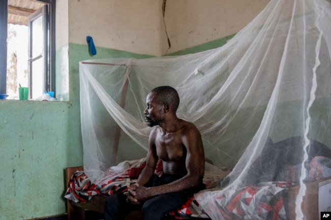 FILE - A man suffering from mpox waits for treatment at the Kamituga General Hospital in South Kivu, Democratic Republic of Congo, Sept. 4, 2024. (AP Photo/Moses Sawasawa, file )