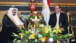 In this picture provided by the office of the Egyptian Presidency, Egyptian President Abdel-Fattah el-Sissi, right, sits with Saudi Arabia's King Salman in the Abdeen Palace, Cairo, April 9, 2016. 