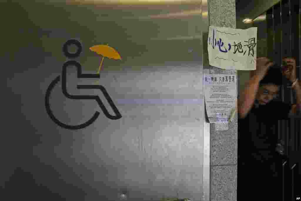 A yellow umbrella sticker is displayed on a public toilet in the occupied areas outside government headquarters in Hong Kong's Admiralty, Oct. 10, 2014.