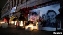 Flowers and candles in memory of Louisa Vesterager Jespersen and Maren Ueland, who were killed in Morocco during a trekking trip, are seen at the Town Hall Square in Copenhagen, Denmark, Dec. 28, 2018. 