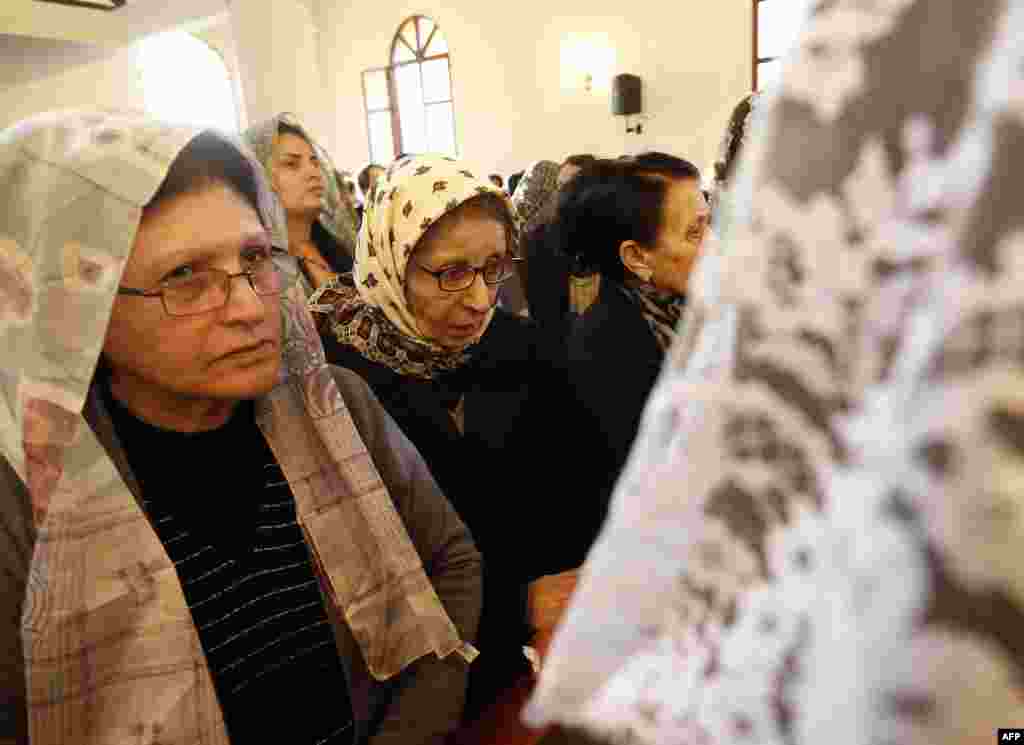 Assyrian Christians, who had fled the unrest in Syria, attend a mass at the Saint Georges Assyrian Church in Jdeideh, northeast of the Lebanese capital Beirut during the Good Friday procession, April 3, 2015. 