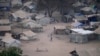 FILE - People stand by their houses in Juba, South Sudan, on February 5, 2023.