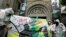 Campaigners dressed as a mock clean-up crew called the 'Greenwash Guerrillas' hold a banner outside the National Portrait Gallery in London, Tuesday, June 22, 2010, where the BP Portrait Award ceremony is held.